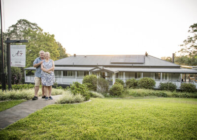 Owners of Avocado Grove BnB in Flaxton, Sunshine Coast Hinterland, standing on front path