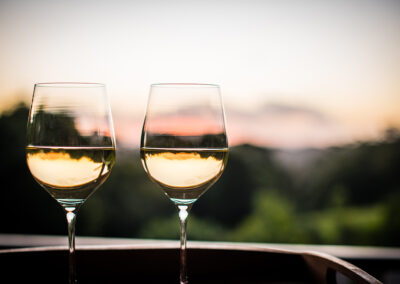 Wine glasses on deck at sunset Avocado-Grove BandB Flaxton, Sunshine Coast Hinterland.